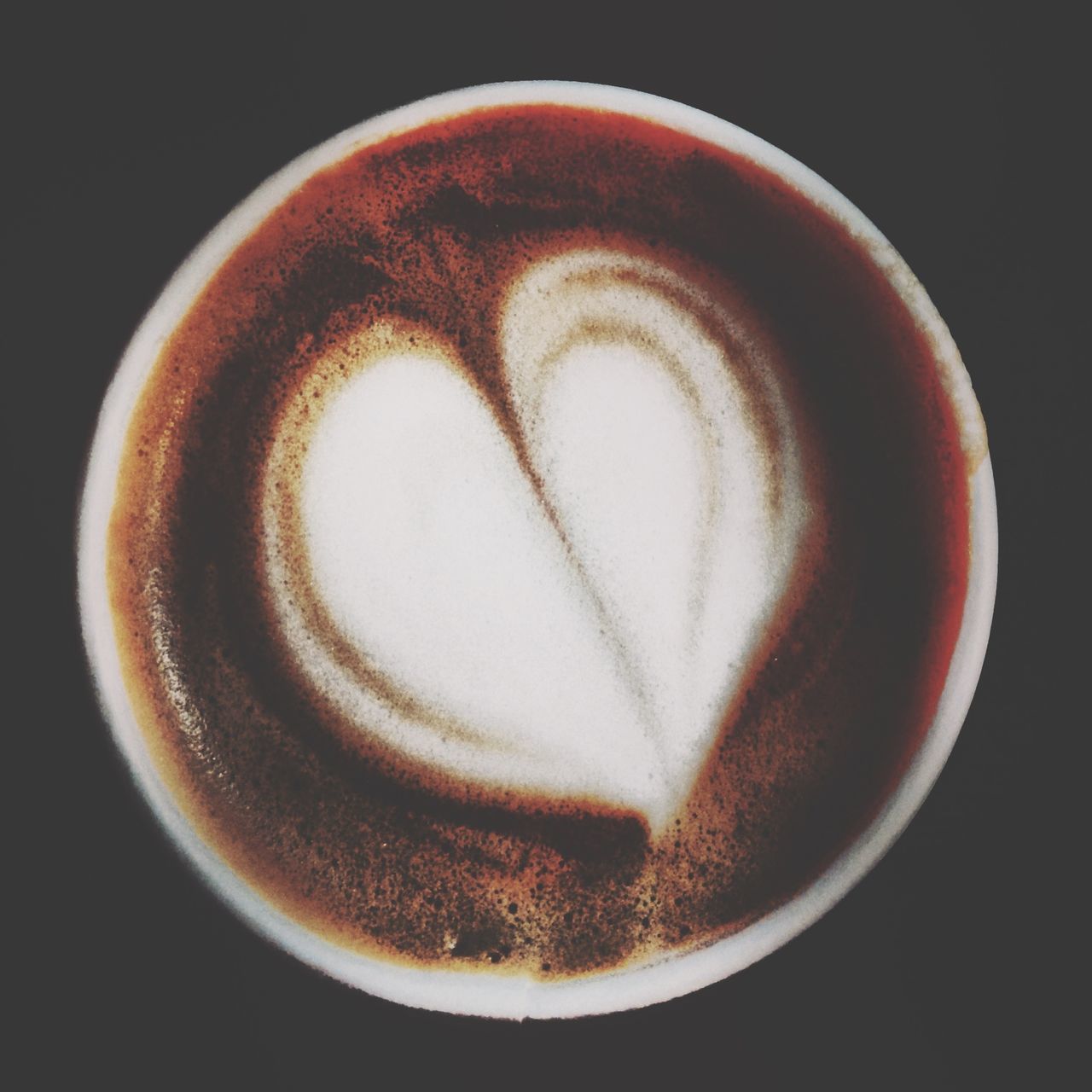 close-up, indoors, still life, food and drink, studio shot, drink, single object, coffee cup, heart shape, table, refreshment, circle, coffee - drink, frothy drink, directly above, black background, cappuccino, high angle view, no people, coffee