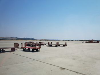 People in row against clear blue sky