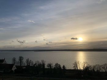 Scenic view of lake against sky at sunset