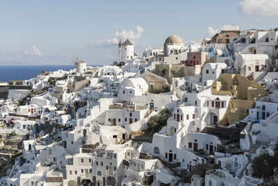 High angle view of townscape by sea against sky