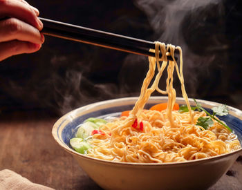 Cropped hand having noodles