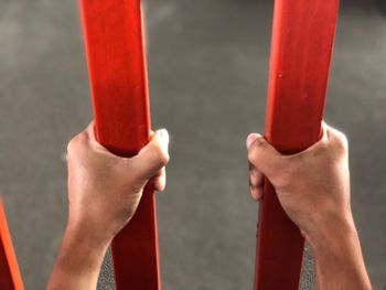 Close-up of people holding metal