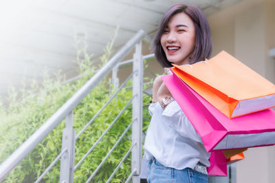 Smiling young woman standing outdoors