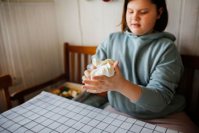 Kid  play with modeling mass, make slime from starch and hair balm. 