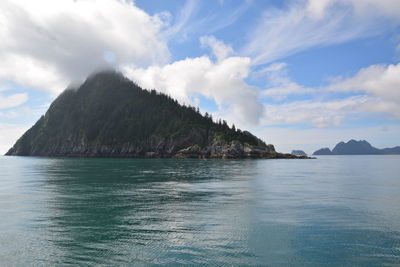 Scenic view of sea and mountains against sky