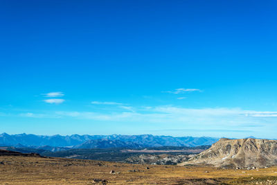 Scenic view of mountains against blue sky