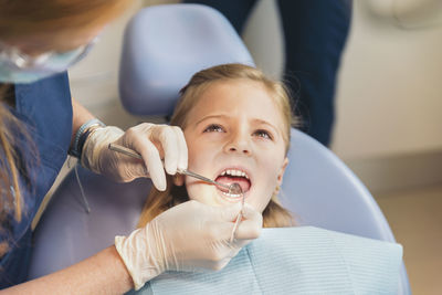 Dentist examining patient mouth in medical clinic