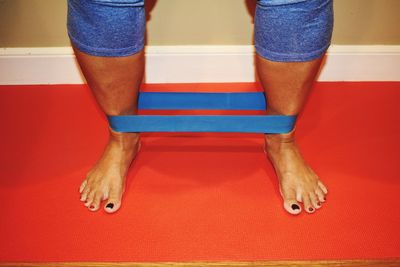 Low section of woman standing on red floor