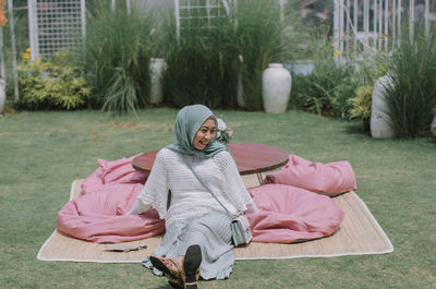 Portrait of woman sitting on field