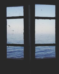 View of sea through window