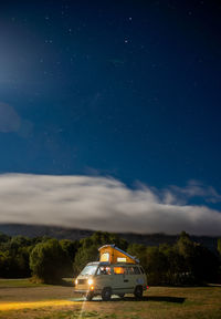 Digital composite image of car on field against sky at night