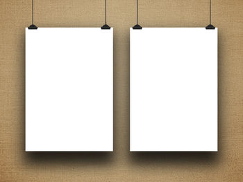 Close-up of blank frames against brown canvas