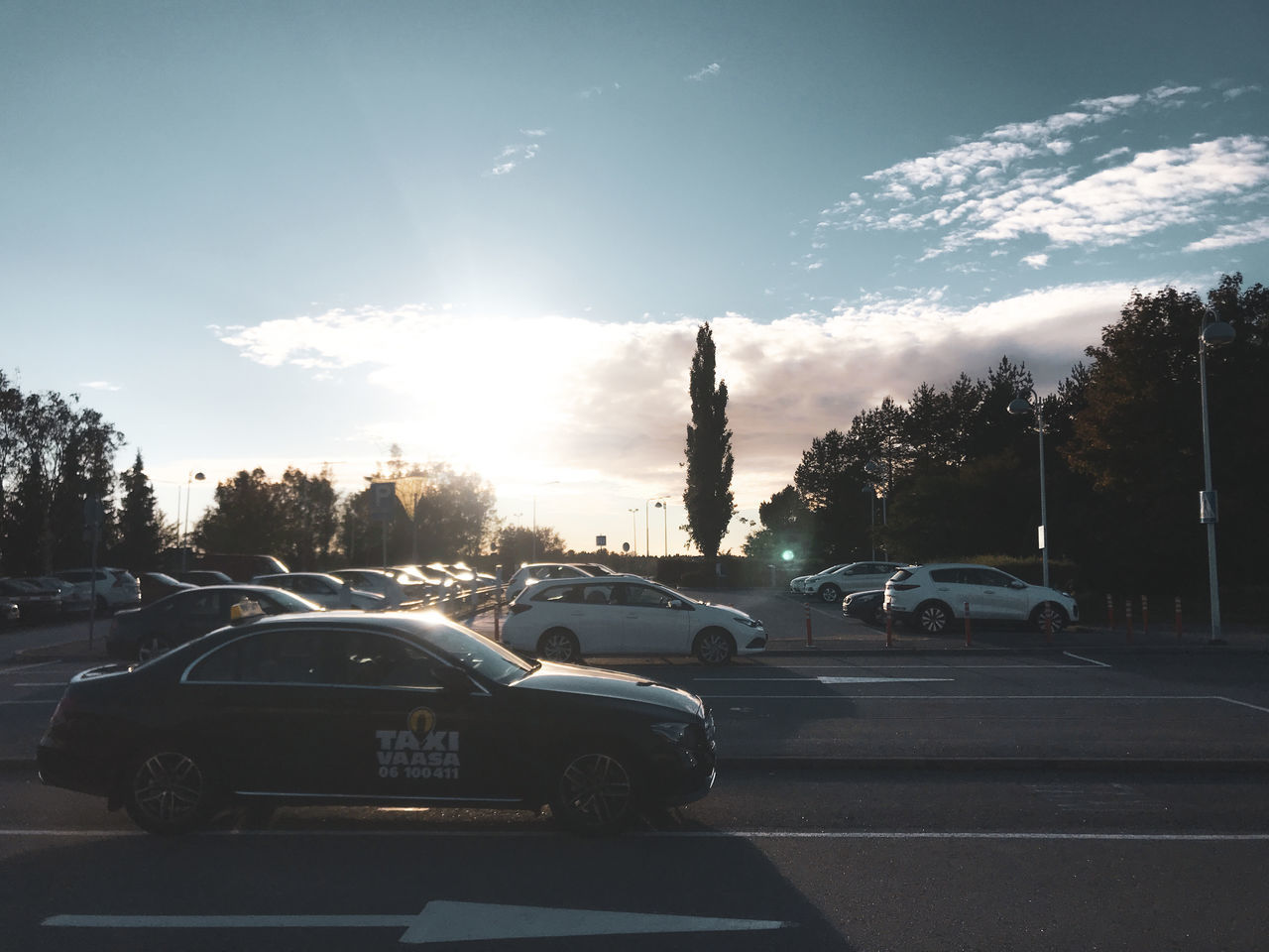 CARS ON ROAD AGAINST SKY