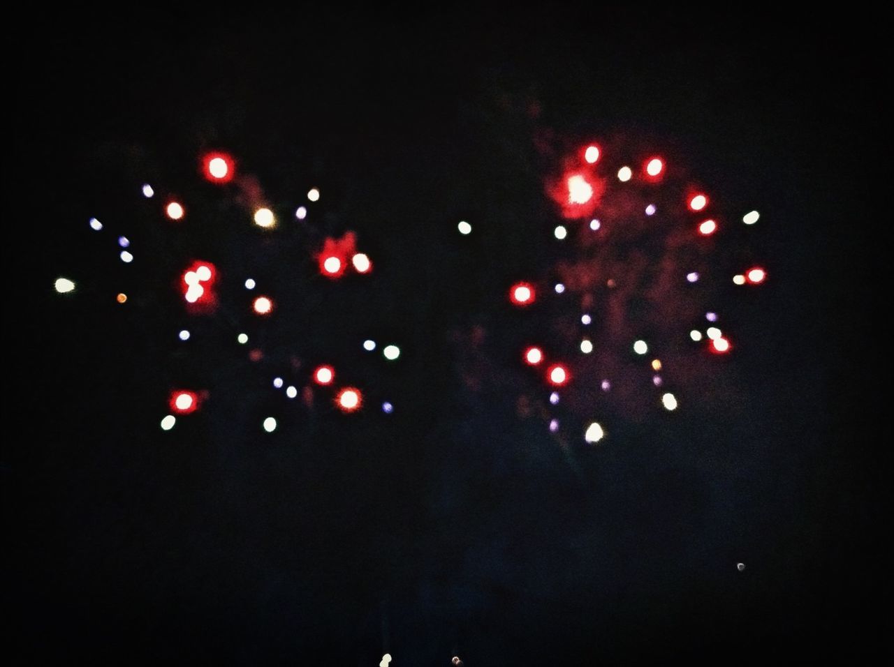 night, illuminated, lighting equipment, dark, celebration, red, low angle view, light - natural phenomenon, decoration, defocused, copy space, glowing, multi colored, christmas, no people, outdoors, sky, clear sky, light, pattern