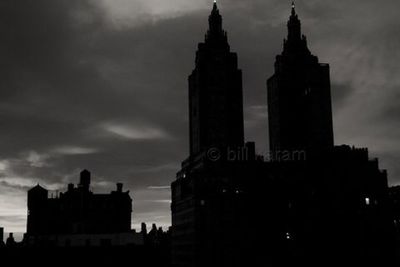 Low angle view of buildings against cloudy sky