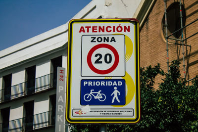 Road sign against built structure