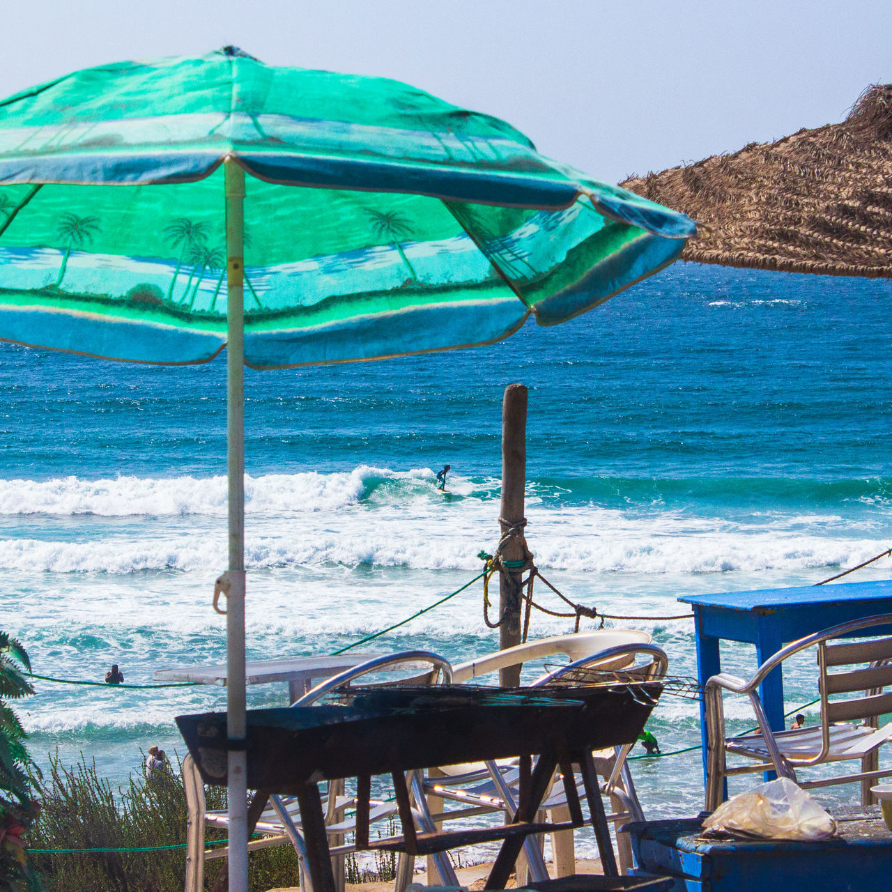 CHAIRS ON TABLE AGAINST SEA