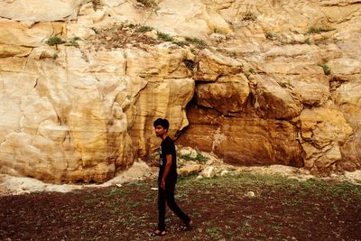 Full length of woman standing on rock