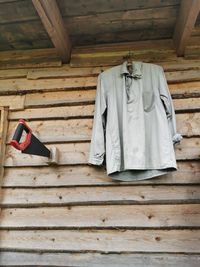 Low angle view of clothes drying against white wall