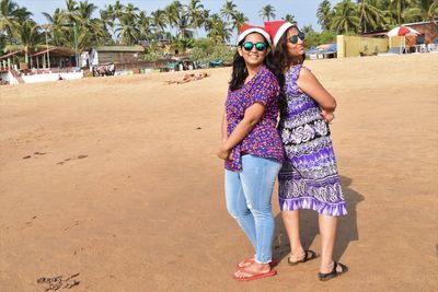 Woman wearing sunglasses standing on beach