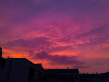 Exterior of buildings in city against dramatic sky