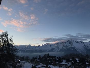 Scenic view of snowcapped mountains against sky during sunset