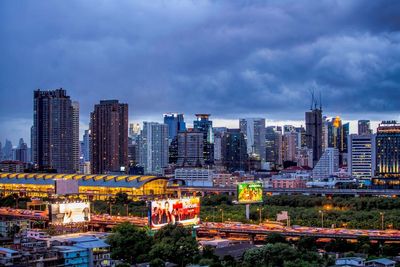 View of cityscape against cloudy sky