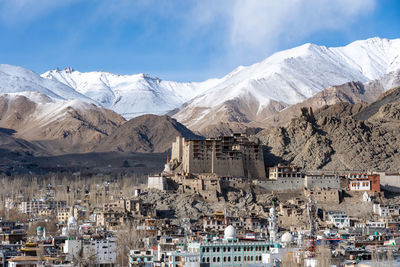 High angle view of townscape and mountains against sky