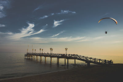 Scenic view of pier over sea against sky during sunset