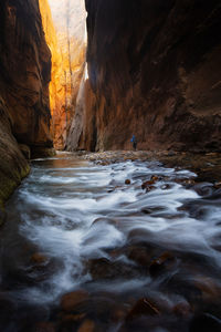 View of river flowing amidst canyon