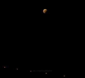 Low angle view of moon against clear sky at night