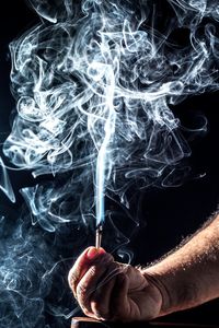 Close-up of hand holding cigarette