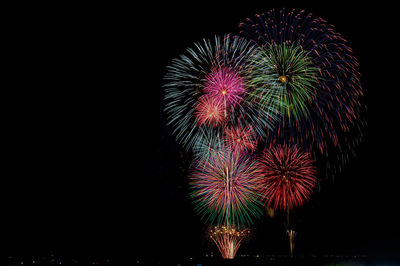 Low angle view of firework display at night