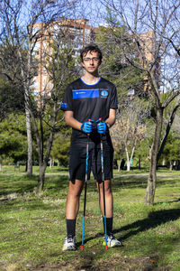 Nordic walking. young person practicing the sport nordic walking with poles in an outdoor park