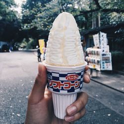 Hand holding ice cream cone