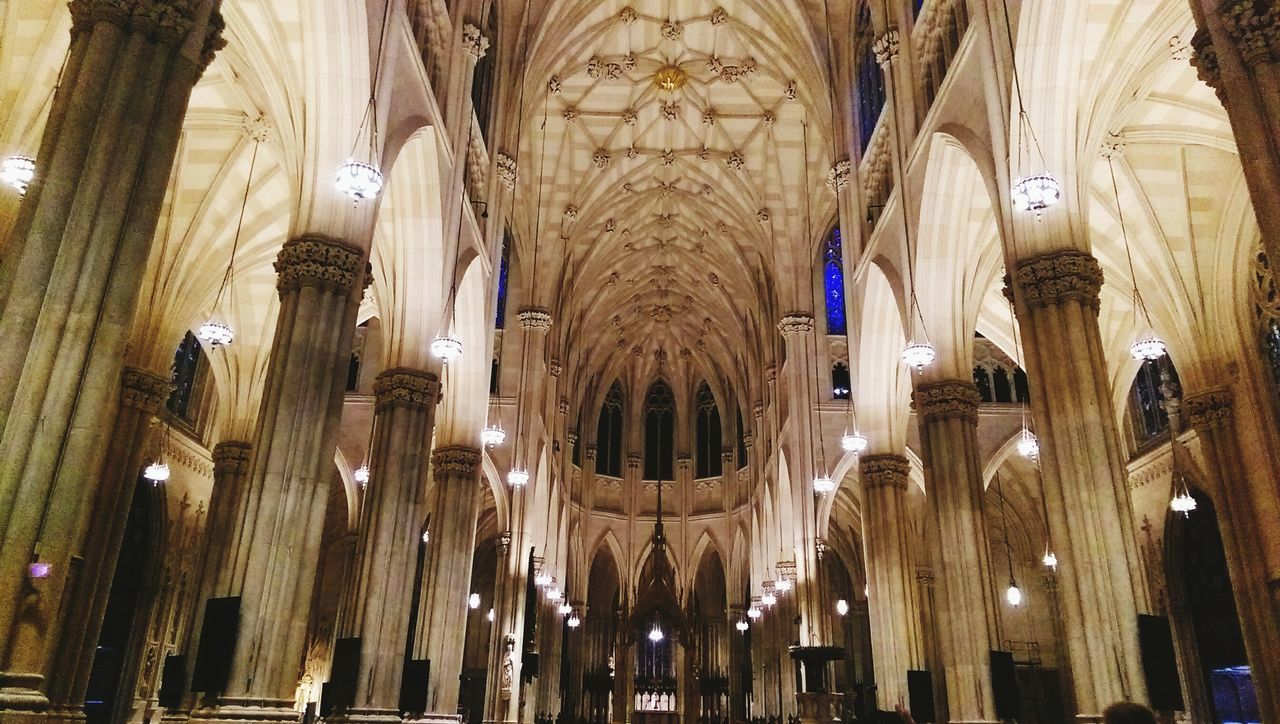 indoors, place of worship, religion, church, spirituality, arch, architecture, illuminated, cathedral, built structure, lighting equipment, ceiling, interior, low angle view, hanging, chandelier, islam, ornate