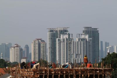 Buildings in city against clear sky