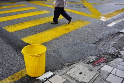 Low section of man standing on road