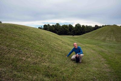 Man examines prehistoric native american burial mounds in mound city ohio