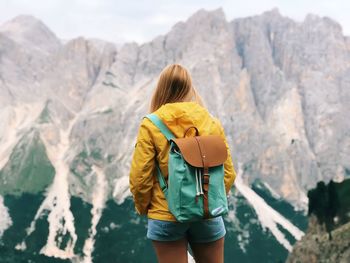 Rear view of woman standing on mountain