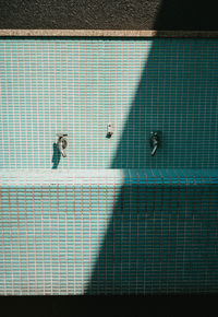 High angle view of people walking by swimming pool