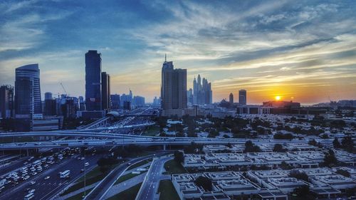 View of cityscape against cloudy sky