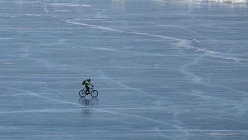 Riding bike at baikal frozen lake