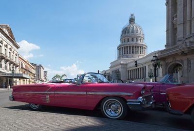 Cars on street against buildings in city