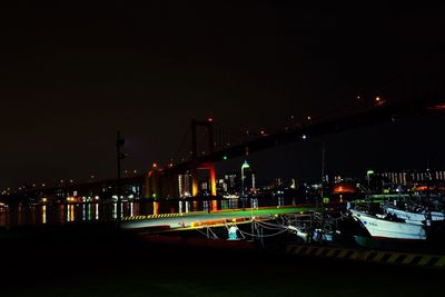 Illuminated city against sky at night