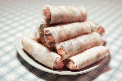 Close-up of spring rolls in plate on table