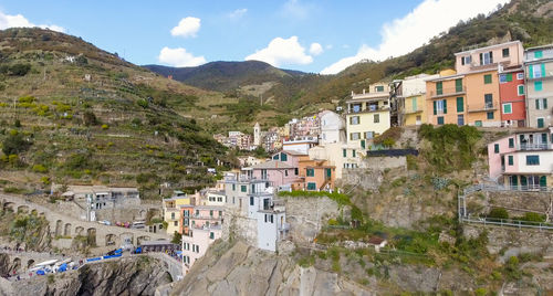 High angle view of townscape by mountain against sky