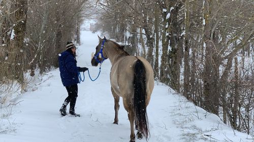 Happyness running on snow covered field with my horse