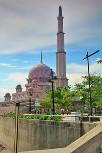 Tourists outside building against sky
