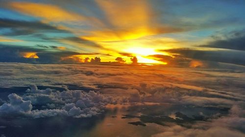 Scenic view of sea against cloudy sky at sunset